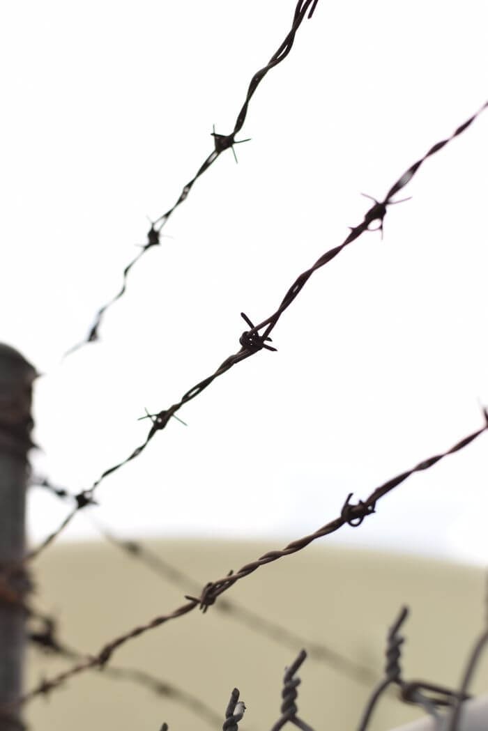 Close-up view of a rusty barbed wire fence in Commerce, California.